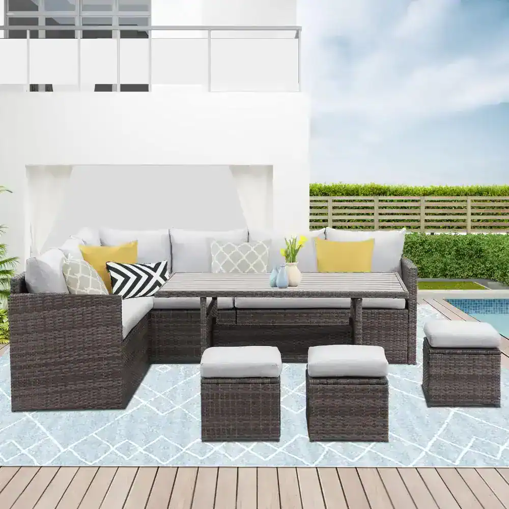 Bright outdoor patio furniture set with wicker sofas, ottomans, and a dining table, perfect for outdoor living and entertaining. Modern design with cushions, ideal for sunny garden or poolside relaxation.