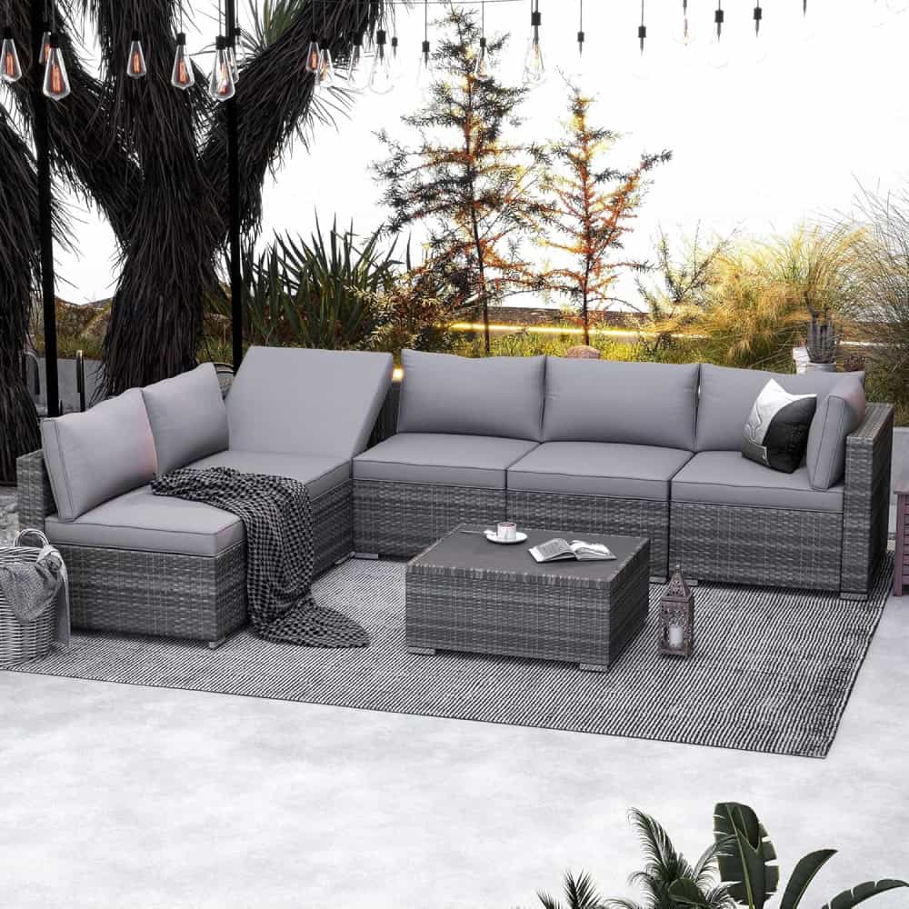 Modern outdoor sectional sofa with gray cushions and woven rattan frame on patio with natural greenery, perfect for stylish outdoor living and entertaining.