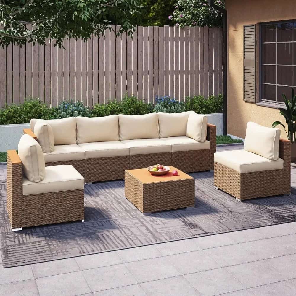 Modern outdoor patio furniture set with wicker sofas and chairs, ideal for garden or backyard lounging, featuring comfortable cushions, on a stylish outdoor rug.