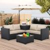 Modern outdoor patio furniture set with black wicker sofas, beige cushions, parasol, and coffee table on a wooden deck with greenery, ideal for stylish outdoor relaxation at Monalisa Store.