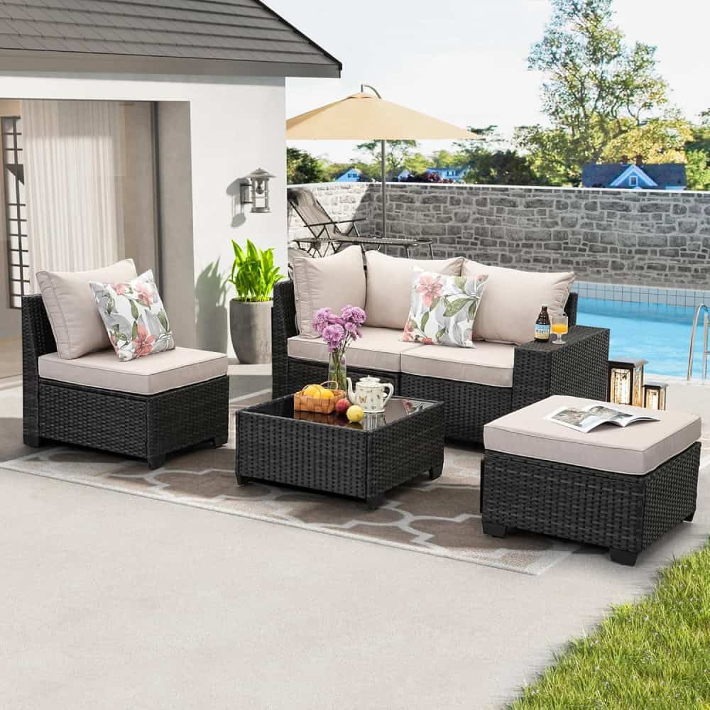 Luxurious outdoor patio furniture set with cushioned wicker sofas, coffee table, and armchair, perfect for relaxing by the pool, featuring floral pillows and garden decor at Monalisa Store.