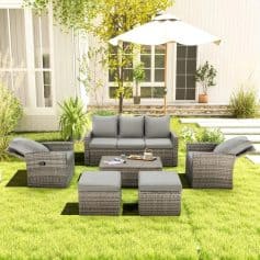 Stylish outdoor patio furniture set with wicker sofas, armchairs, and ottomans beneath a large patio umbrella, ideal for garden or backyard relaxation and entertaining.