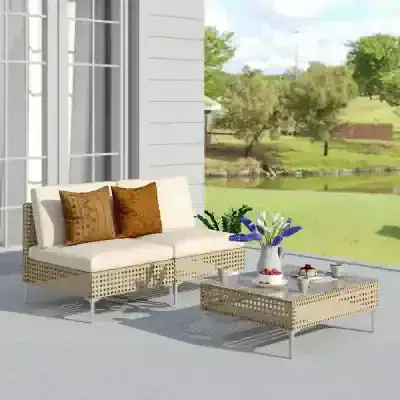 Elegant outdoor patio furniture with neutral cushions and decorative pillows, set in a peaceful garden view; perfect for relaxing and entertaining.