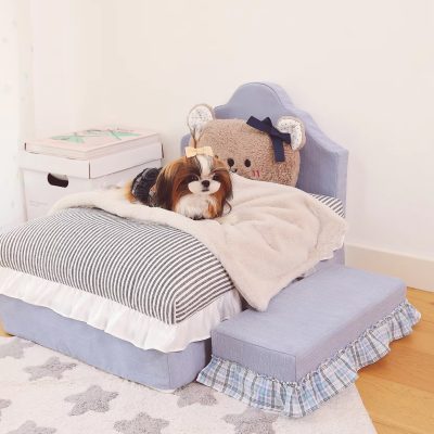 Dog lying on a small bed with plush teddy bear pillow in a cozy room, Monalisa Store, pet furniture, canine comfort bed, adorable dog accessories, home decor for pets, pet comfort and style, stylish pet beds for dogs, Monalisa pet product collection, pet-friendly interior design.