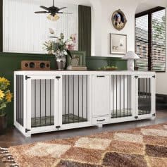 Modern white pet playpen with black metal bars ideal for small dogs or cats, featuring storage drawer and decorative elements in a stylish living room setting.