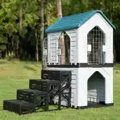 White plastic pet house with stairs and metal fencing for outdoor cats or small animals.