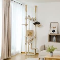 Luxurious multi-level cat tree with scratching posts, perches, and cozy hideouts in a modern living room, perfect for entertaining and exercising cats.