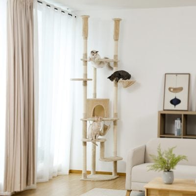 Luxurious multi-level cat tree with scratching posts, perches, and cozy hideouts in a modern living room, perfect for entertaining and exercising cats.