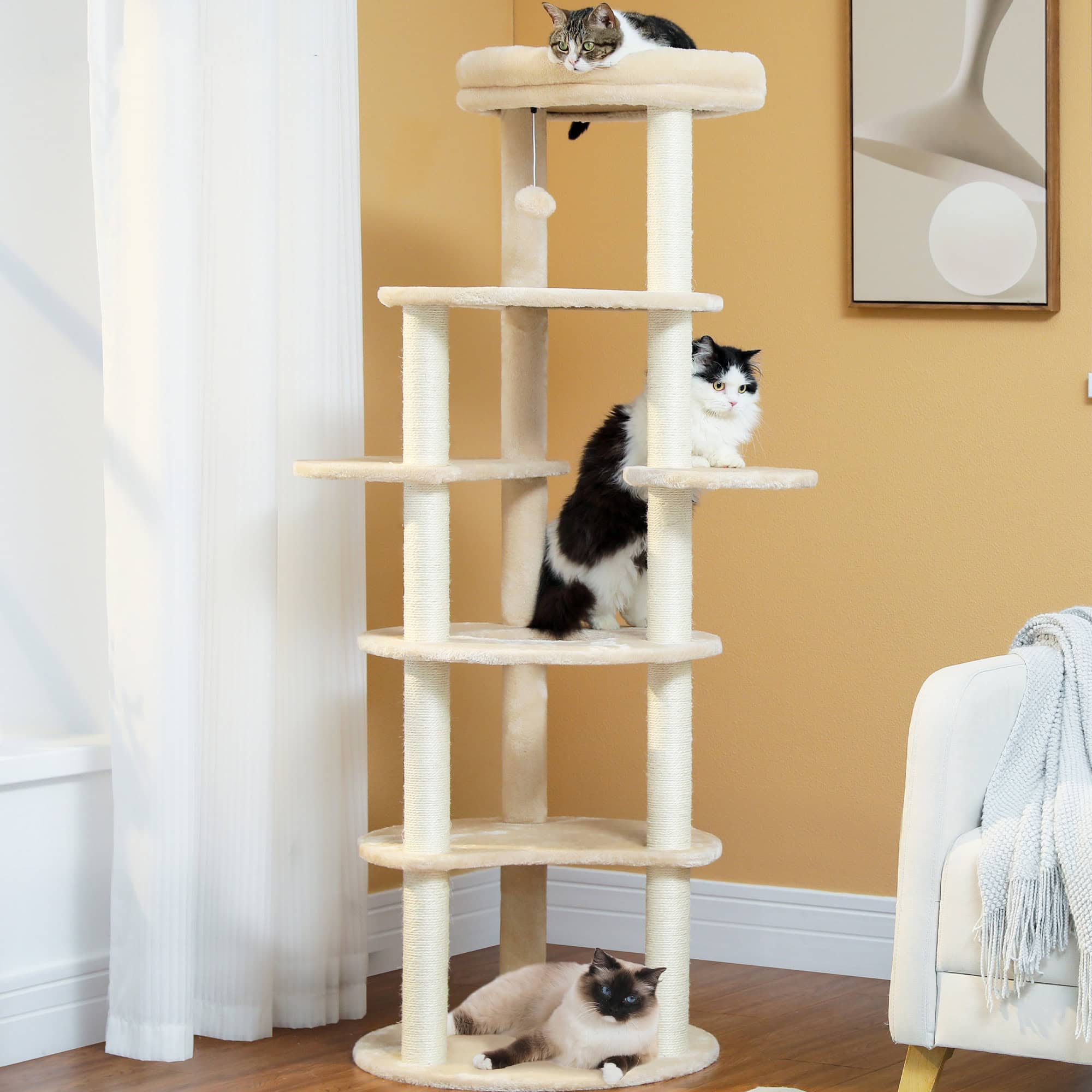 Fluffy cat tree for pets with multiple levels and scratching posts, ideal for cats to climb and play, located in a cozy living room setting with kittens and elegant wall art.