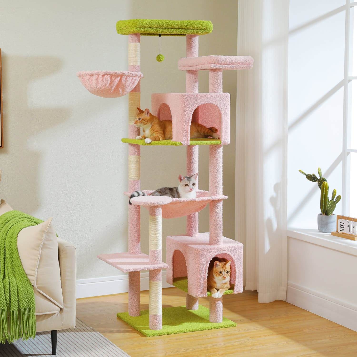 Colorful pink and green multi-level cat tree with scratching posts and cozy hideouts, ideal for entertaining and grooming cats in a stylish home environment.