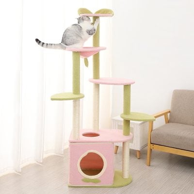 Fluffy cat climbing pink and green multi-level cat tree with cozy cubby and scratching posts, perfect for entertainment and comfort, ideal for pet owners seeking high-quality cat furniture.