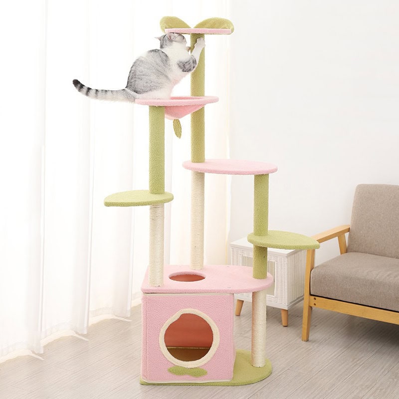 Fluffy cat climbing pink and green multi-level cat tree with cozy cubby and scratching posts, perfect for entertainment and comfort, ideal for pet owners seeking high-quality cat furniture.