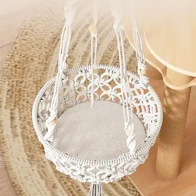Handcrafted white macrame baby swing for nursery decor and comfort, perfect for gentle rocking and soothing infants, stylish addition to any modern or boho baby room.