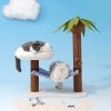 Cat lying on a white fluffy platform on a cat tree with a striped hammock, palm tree, and blue sky background.