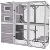 Metal outdoor animal enclosure, large pet cage with multiple levels and shaded areas for cats or small animals.