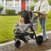 Dog stroller in outdoor park scene with a happy small dog sitting inside, perfect for pet transportation and outdoor adventures. Features durable wheels and a spacious, comfortable carriage for small pets.