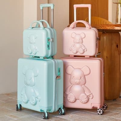 Colorful teddy bear luggage sets in pastel pink and turquoise, perfect for kids and family travel, stylish and durable with lockable compartments and 360-degree spinner wheels.