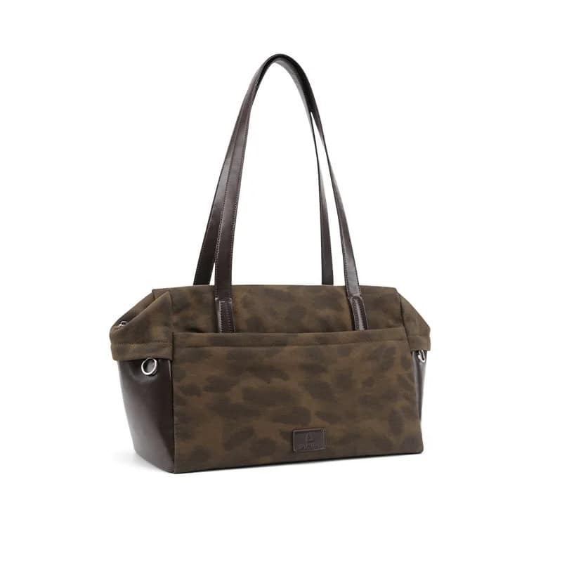 Stylish brown canvas tote bag with leather handles, ideal for shopping or daily use, featuring spacious compartments and durable construction for versatile fashion and functionality.