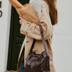 Bag with a leather strap and a soft exterior, perfect for ladies carrying everyday essentials including a baguette, books, or accessories, stylish and functional.