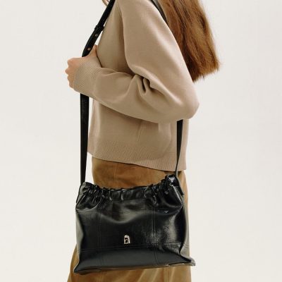 Stylish black leather handbag with drawstring closure, perfect for everyday use and fashion-forward accessories. Monalisa Store offers premium quality handbags for women.