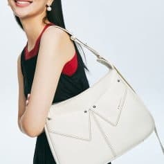 Elegant woman carrying a white designer handbag, showcasing luxury fashion accessories at Monalisa Store. Perfect for style-conscious shoppers and accessory enthusiasts.