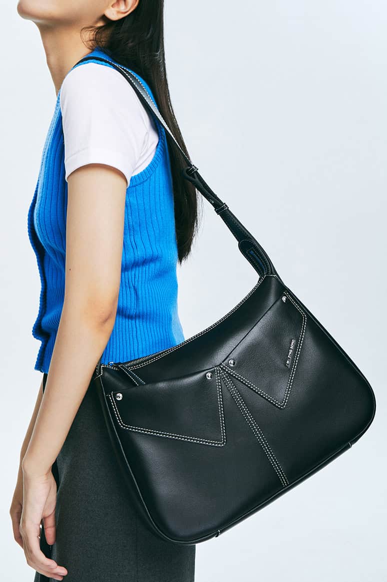 Elegant black designer handbag with contrasting white stitching, perfect for fashion-forward women, showcased at Monalisa Store, ideal for accessories and luxury eyewear shopping.