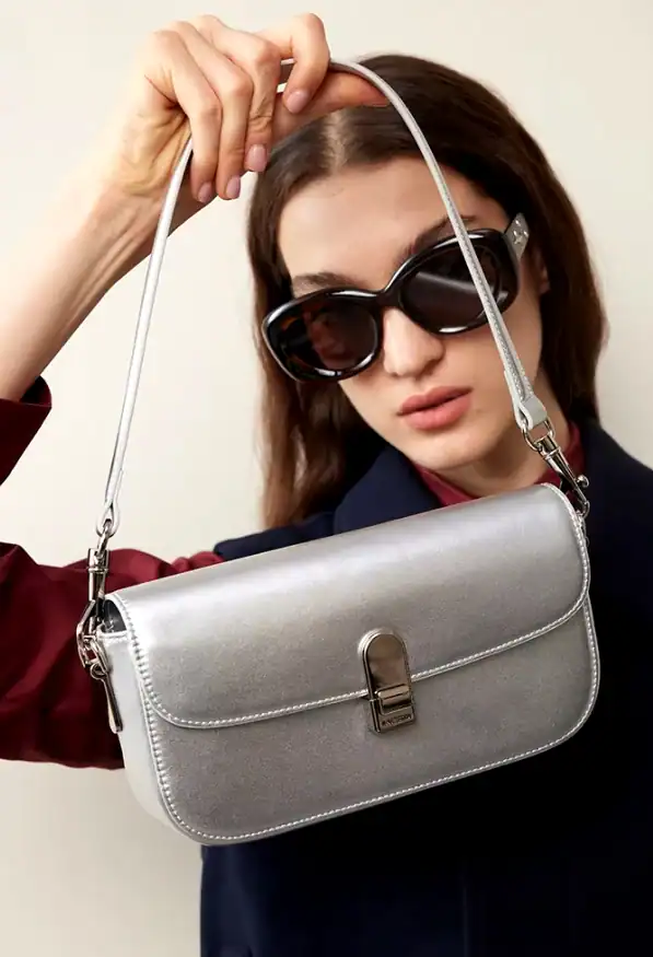 Elegant black sunglasses with a stylish handbag and fashionable outfit, showcasing trendy accessories available at Monalisa Store for modern women.