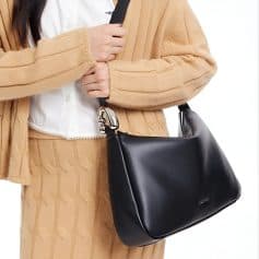 Stylish black leather handbag with silver accents, perfect for sophisticated fashion and daily use, showcased in a chic outfit at Monalisa Store.