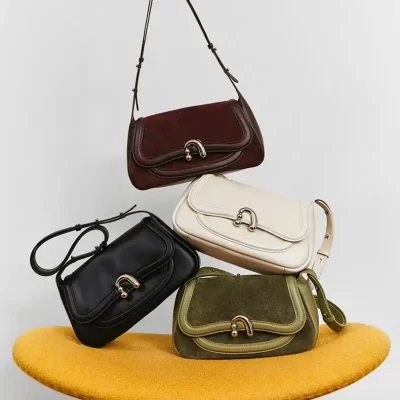 Elegant designer handbags displayed on a modern mustard-colored stool, showcasing Monalisa Store's premium collection of fashion accessories, perfect for stylish women seeking high-quality purses.