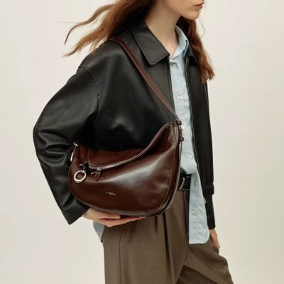 Elegant brown leather shoulder bag for women, stylish and versatile accessory for daily use, travel, or work. Crafted from high-quality leather with durable zippers and a fashionable design.