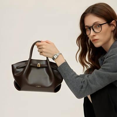 Stylish woman holding designer handbag, fashion accessories, modern look, opt for luxury handbags from Monalisa Store for trendy fashion and accessories.