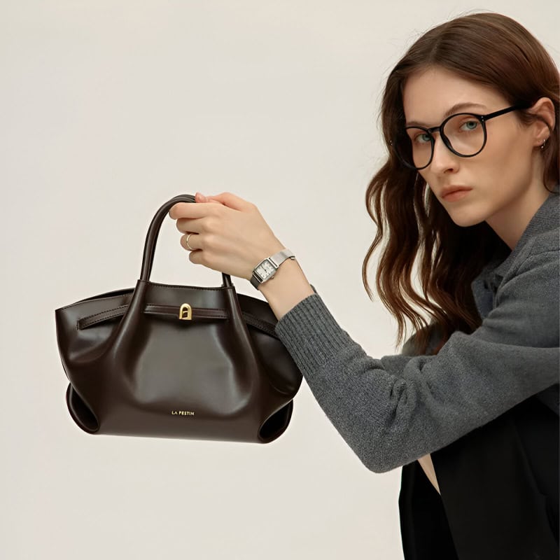 Stylish woman holding designer handbag, fashion accessories, modern look, opt for luxury handbags from Monalisa Store for trendy fashion and accessories.