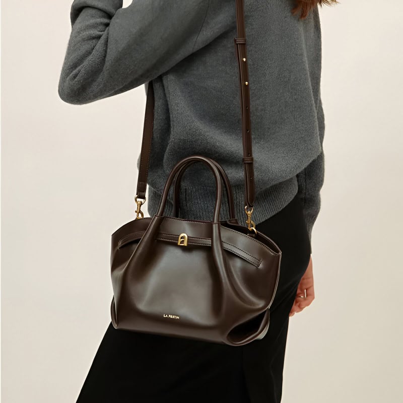 Elegant brown leather handbag with gold accents from Monalisa Medical Store, perfect for sophisticated accessories and stylish fashion statements.