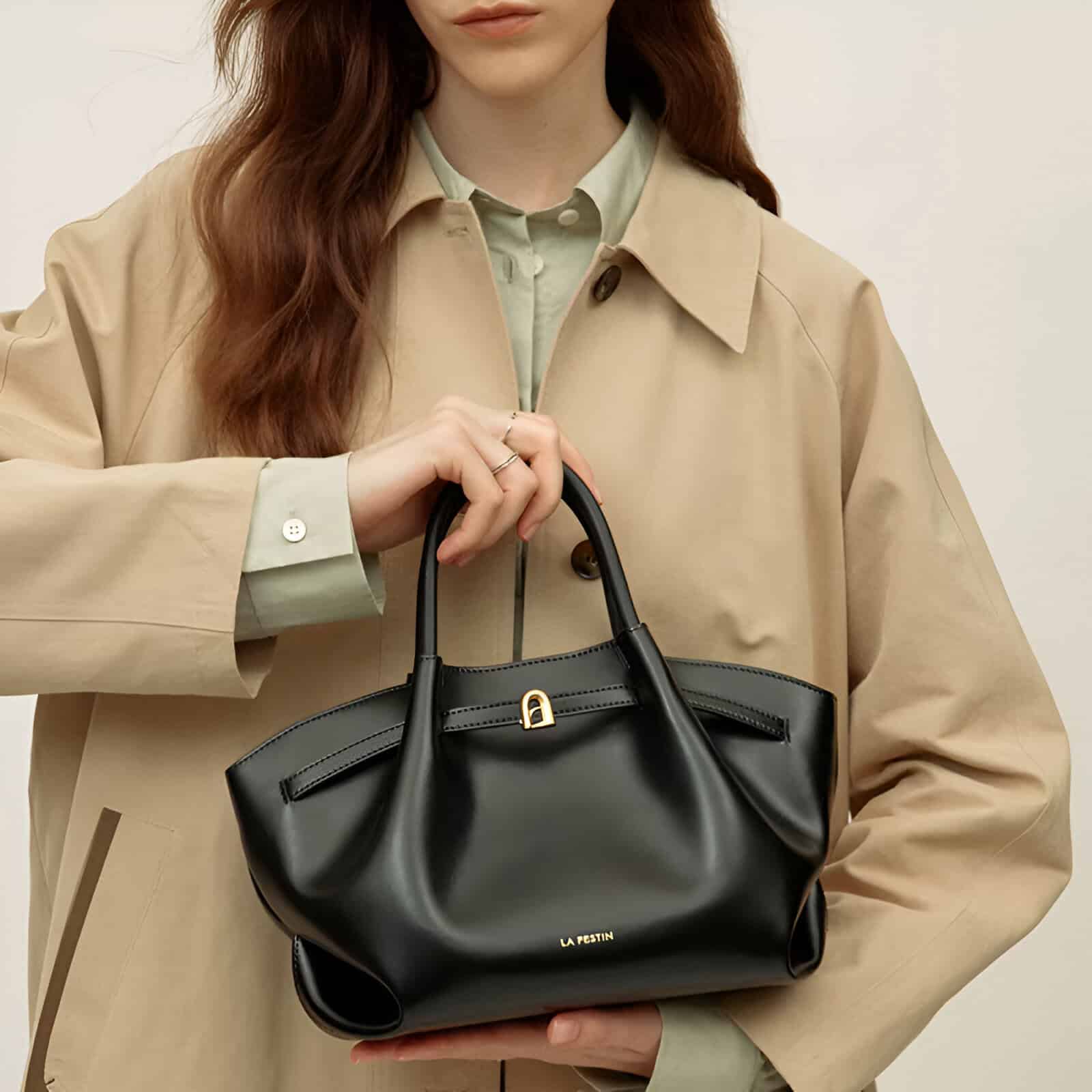 Luxurious black leather handbag with gold-tone hardware and embossed logo, ideal for stylish women seeking premium designer accessories from Monalisa Store.