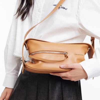 Tan leather crossbody bag with front zipper pocket and adjustable strap for women’s fashion and accessories.
