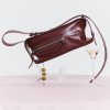 Soft leather burgundy handbag with zippered pocket, stylish for women. Perfect for fashion accessories and daily use. Features adjustable strap and modern design.