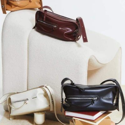 Leather handbags displayed on a minimalist white furniture piece, showcasing Monalisa Store's stylish and high-quality collection of luxury accessories for women.