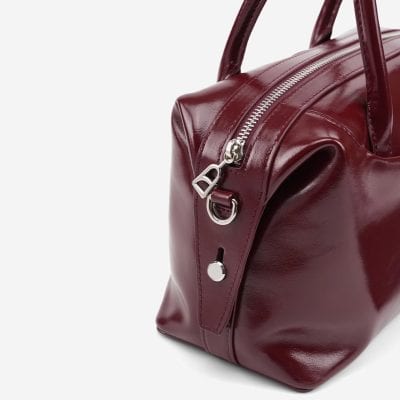 Luxurious burgundy leather handbag with silver zipper and hardware, perfect for fashion-forward accessories at Monalisa Medical Store.