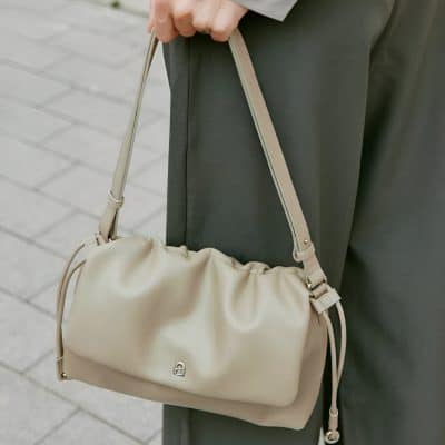 Luxury beige handbag with adjustable strap, close-up shot at Monalisa Store, stylish women's fashion accessory for everyday use and elegance, ideal for enhancing casual and formal outfits.