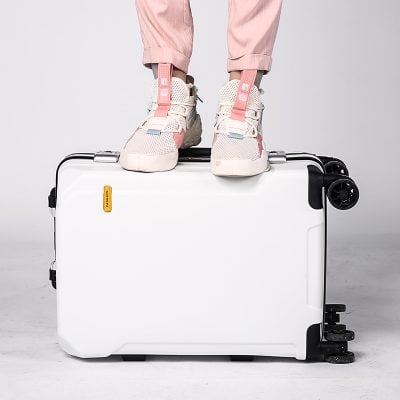 Lightweight white travel suitcase with pink sneakers on top, suitable for stylish trips and convenient mobility. Perfect for travelers seeking durable, trendy luggage for easy packing and transport.