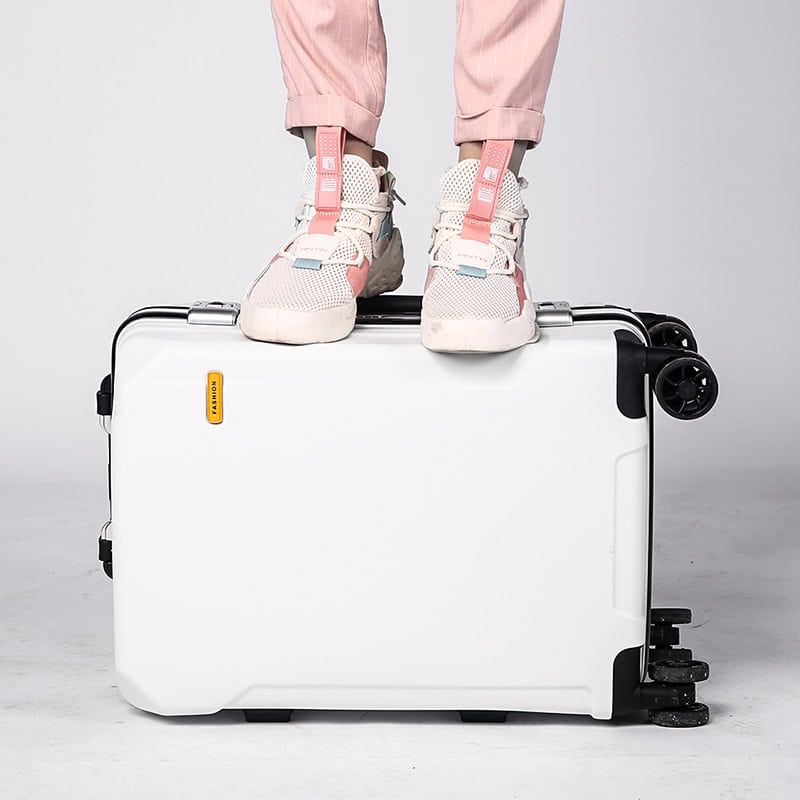 Lightweight white travel suitcase with pink sneakers on top, suitable for stylish trips and convenient mobility. Perfect for travelers seeking durable, trendy luggage for easy packing and transport.