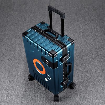 Hard-shell blue travel suitcase with electronic lock on grey carpet floor.