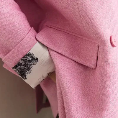 Elegant pink blazer with tailored design, featuring a lapel collar, button closure, and precise stitching, perfect for professional or chic occasions. Made from high-quality fabric for a polished look.