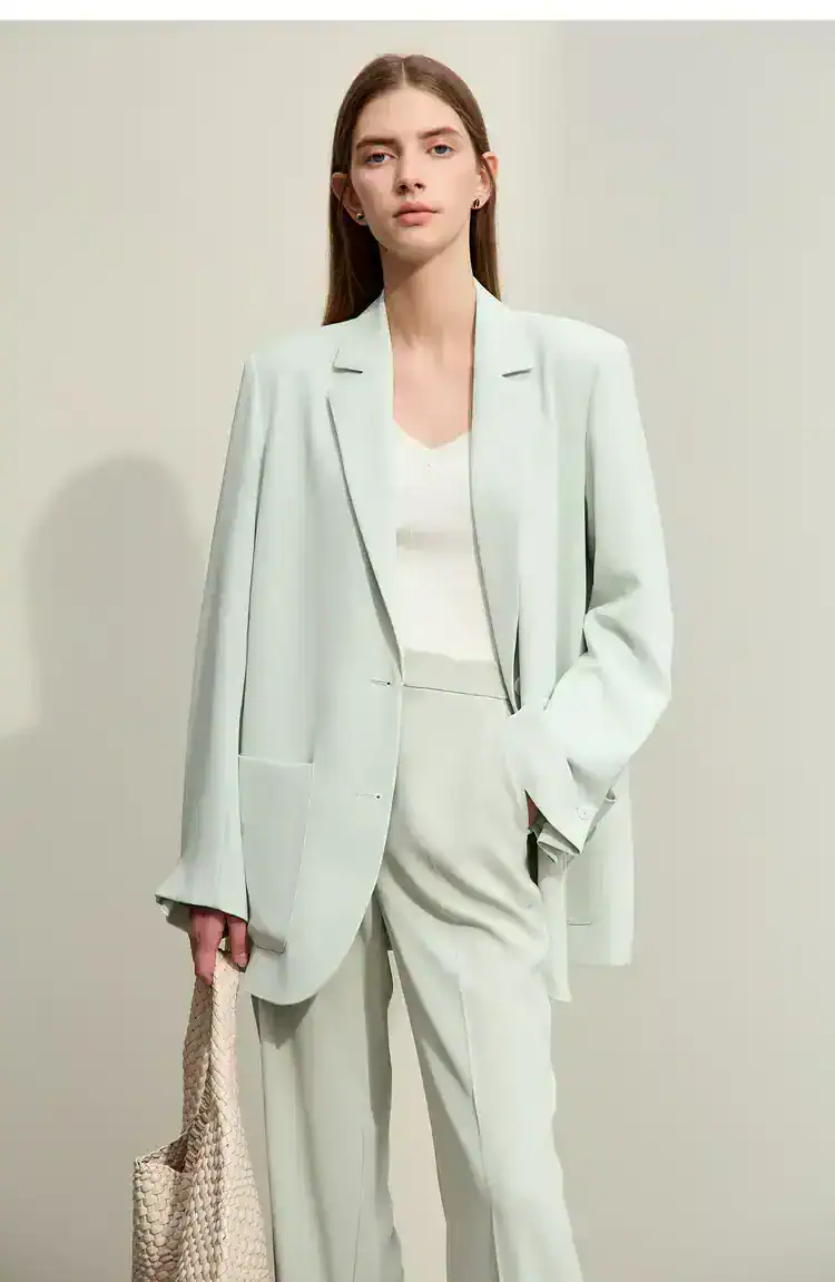 Luxurious white tailored suit set for women, perfect for professional or formal occasions, featuring a stylish blazer, matching pants, and elegant accessories.