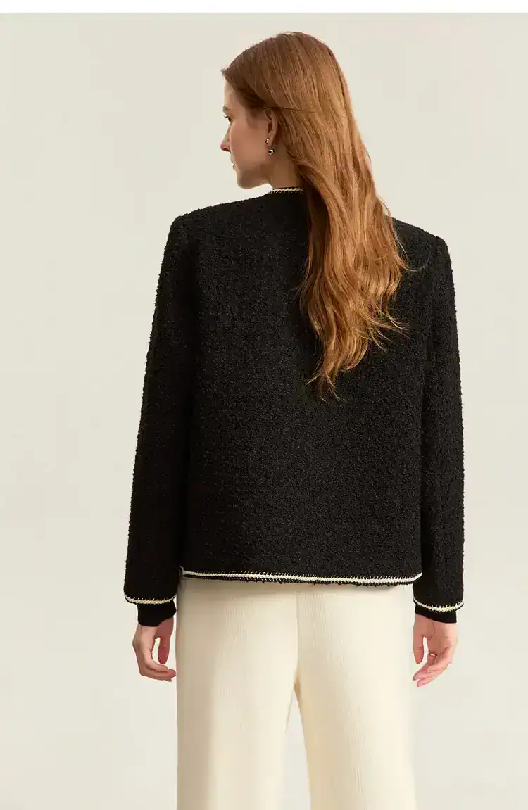 Elegant black textured blazer with white trim, perfect for sophisticated fashion statements and professional look. Monalisa Store offers stylish, high-quality women's clothing.