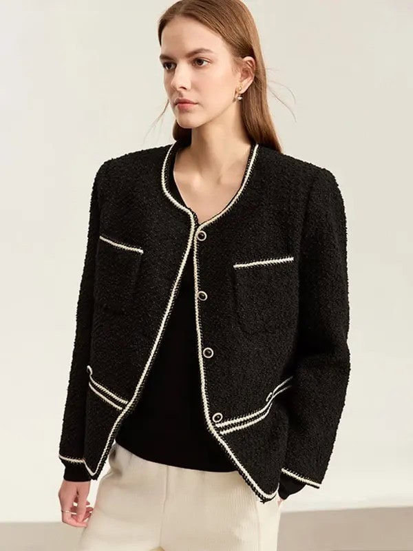 Black textured blazer with white piping, chic and professional for women.