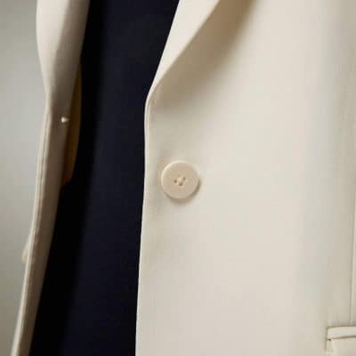 Elegant white blazer with a classic button detail, perfect for professional and stylish office wear, available at Monalisa Store for optometry and fashion-forward clientele.