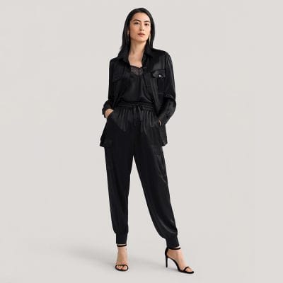 Chic black satin loungewear set featuring a matching cropped jacket and jogger pants, perfect for stylish comfort and casual or versatile fashion looks.
