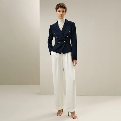 Elegant navy blue double-breasted blazer paired with white wide-leg trousers, perfect for sophisticated office wear or formal occasions, showcasing modern fashion style.