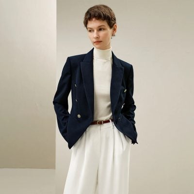 Elegant professional woman wearing a navy blazer and white trousers, showcasing Monalisa Store's stylish and sophisticated fashion collection for women.